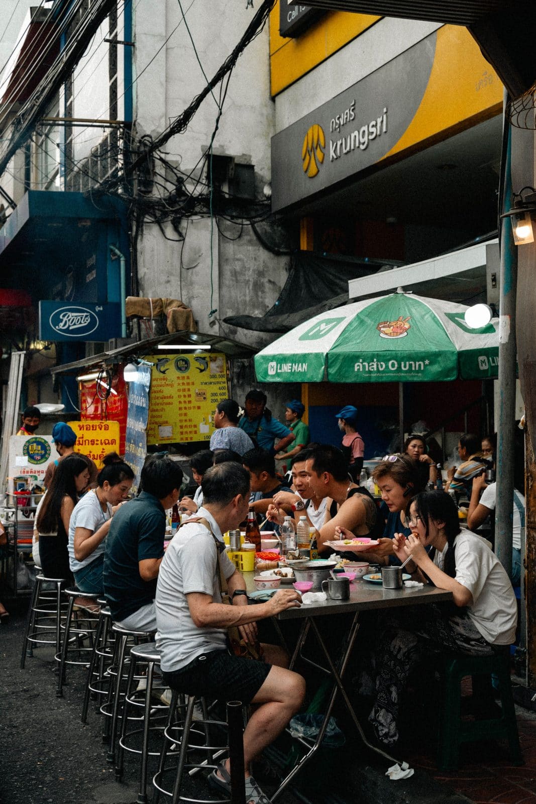Traveler attempting to order food at a street stall abroad, pointing at a menu