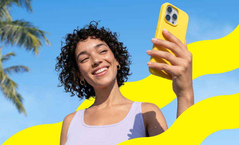 Saily travel eSIM campaign image showing a traveler using a smartphone