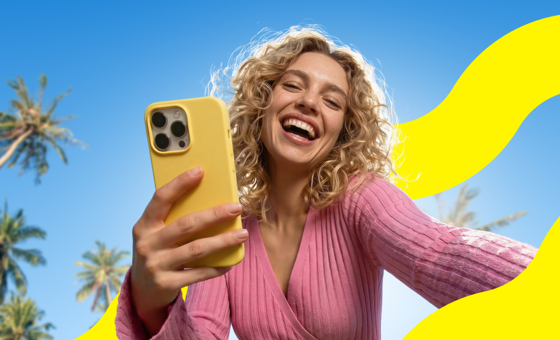 Saily campaign image of a traveler smiling while using a smartphone