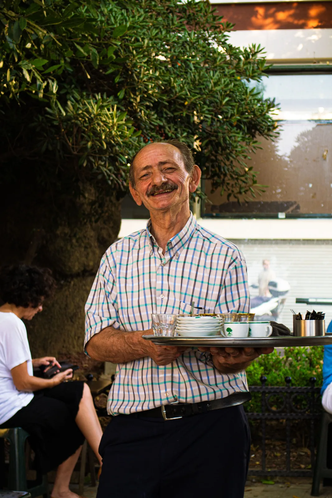 Waiter holding a serving tray in a restaurant