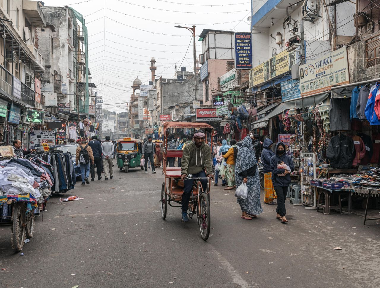 Cycle rickshaw on a crowded street market in Old Delhi