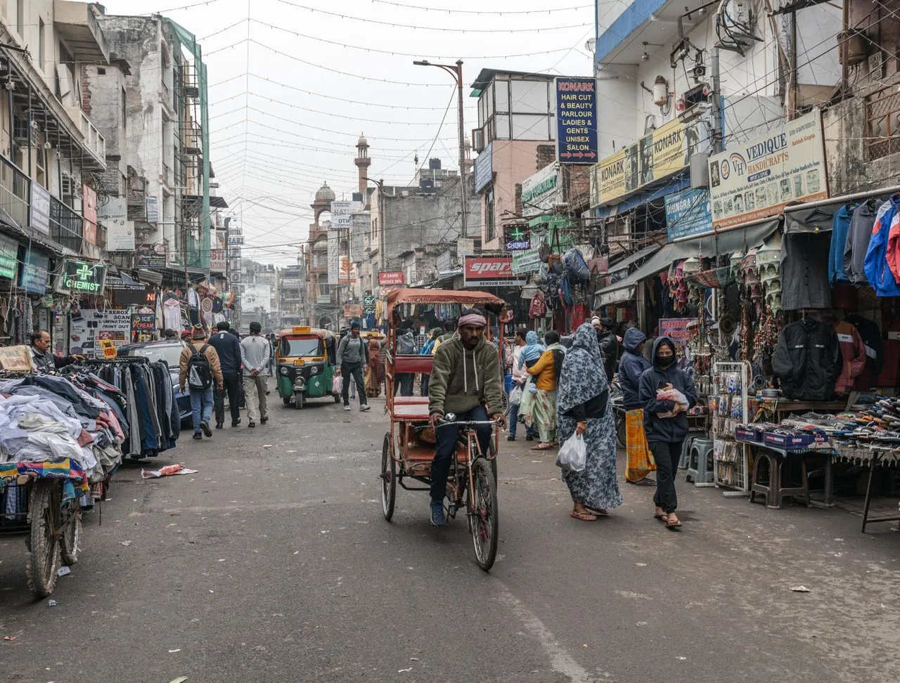Cycle rickshaw on a crowded street market in Old Delhi