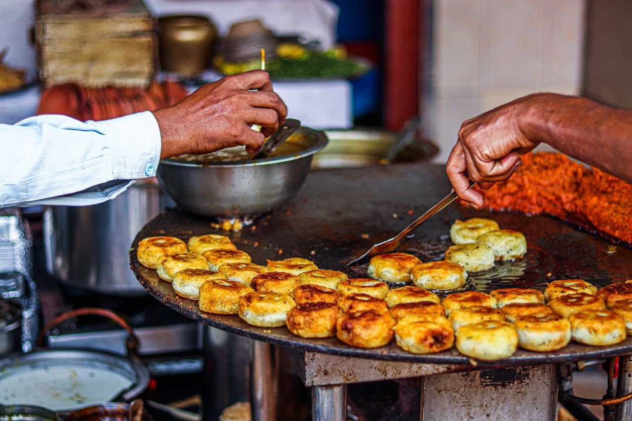 Street vendor frying misal pav ingredients in Pune