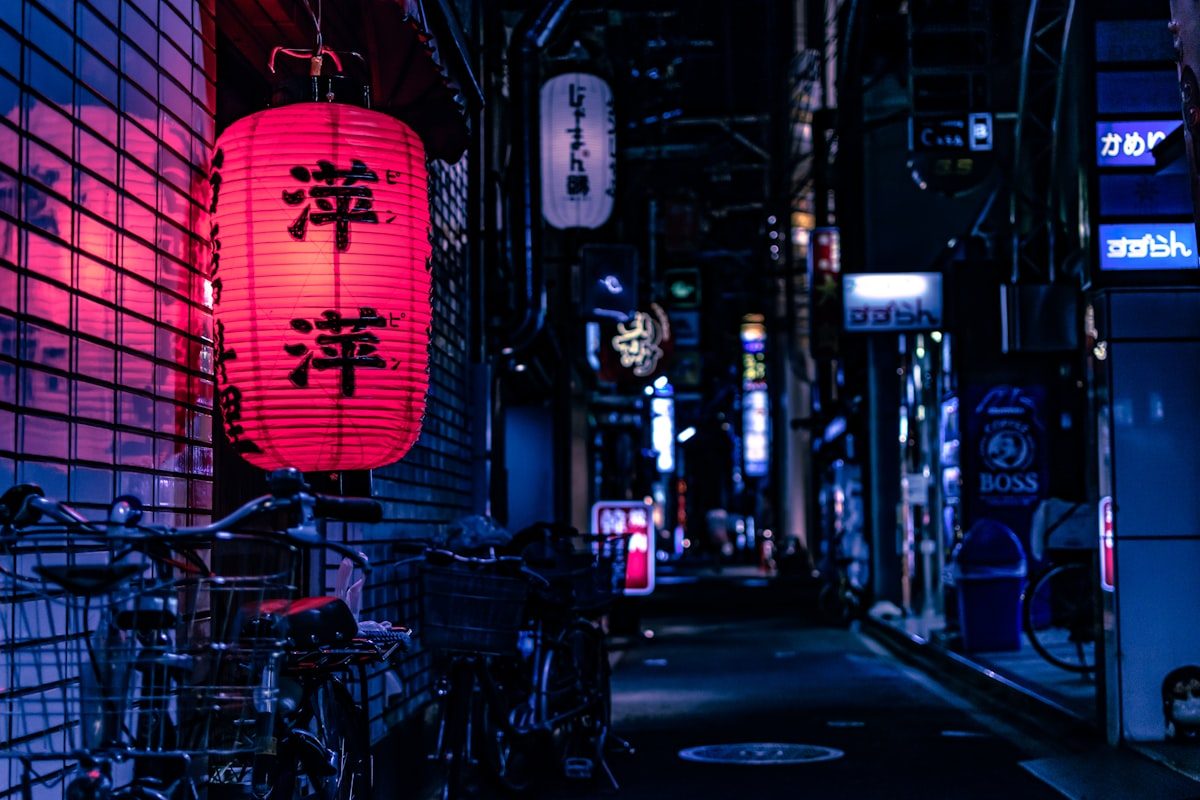 Lantern-lit night market street in Japan with food stalls