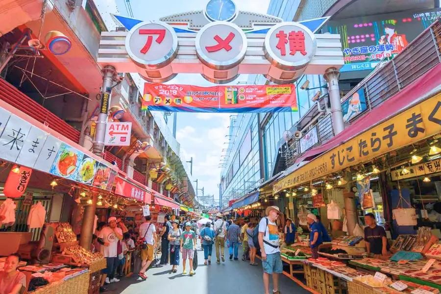 Ameyoko market street in Tokyo crowded with shoppers and food vendors