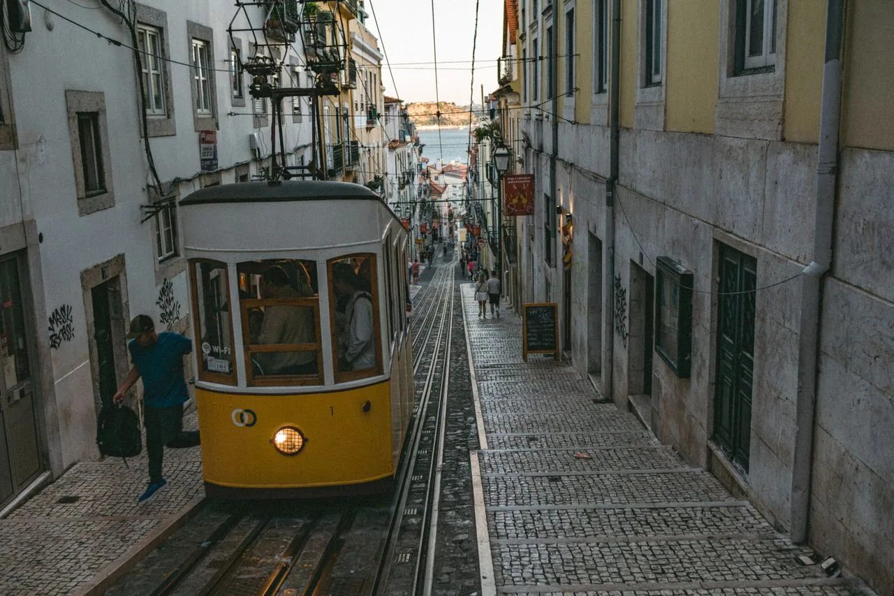 Lisbon's yellow Tram 28 on a hill street in the Alfama quarter: Portugal food allergy travel guide