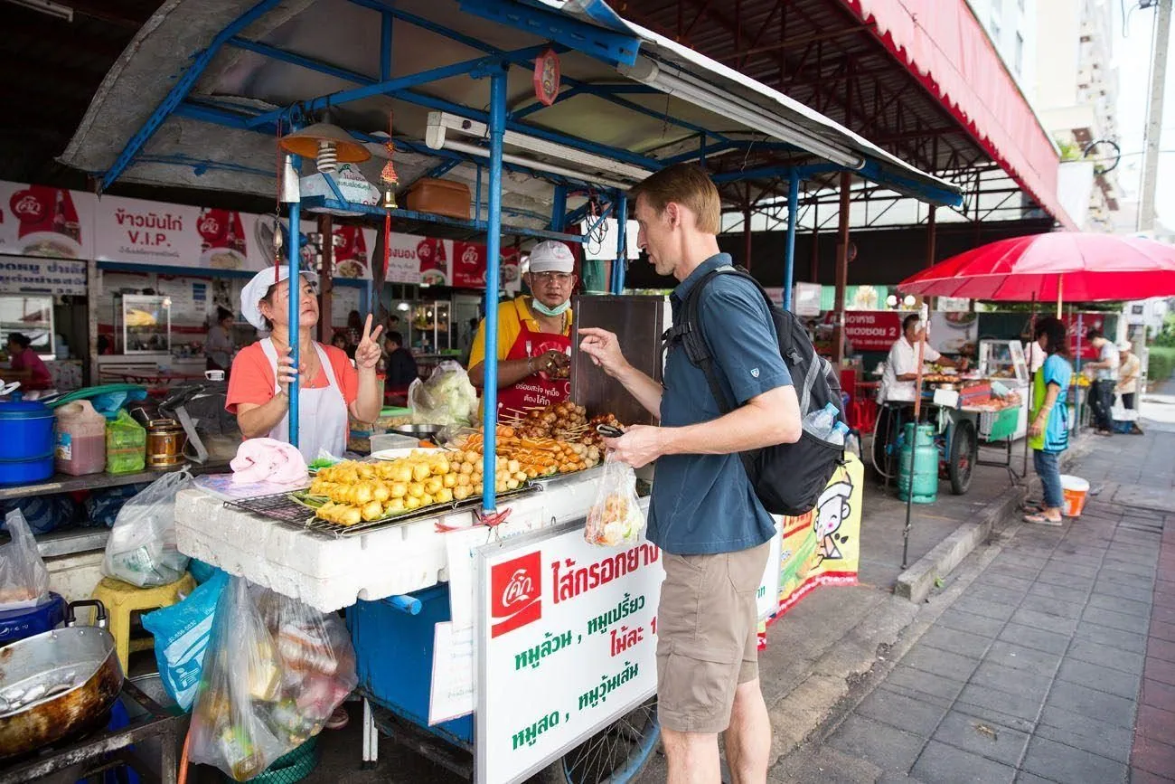Thailand street food market with vendors and evening crowds