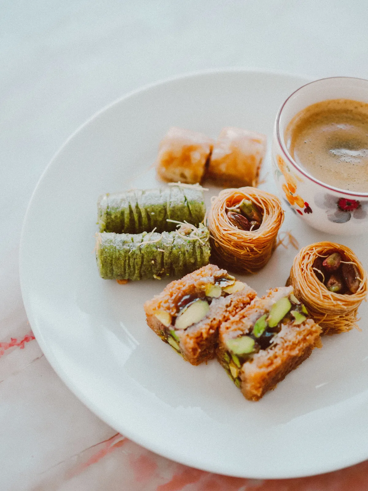 Baklava pastries on a plate with coffee
