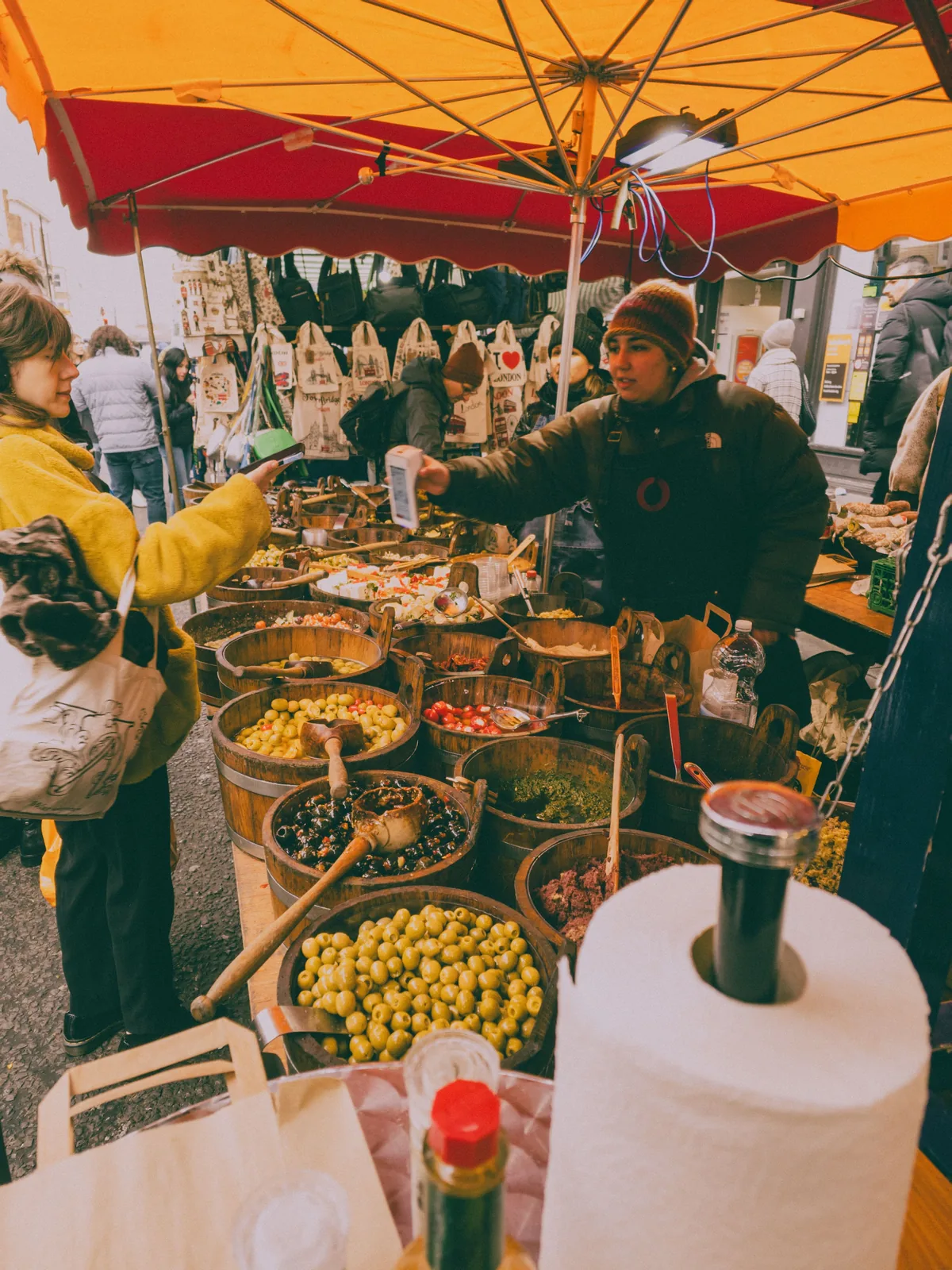 Outdoor market stall with red umbrella and fresh produce