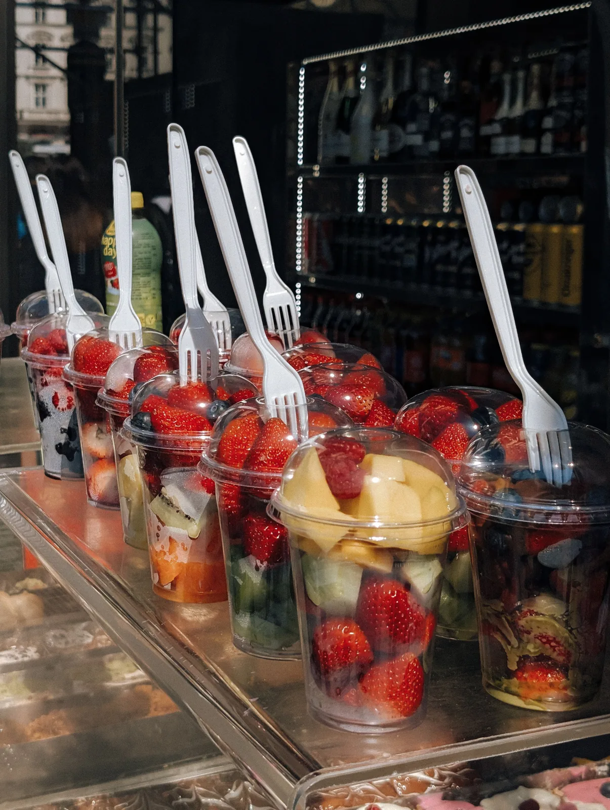 Street vendor stand with fresh fruit cups