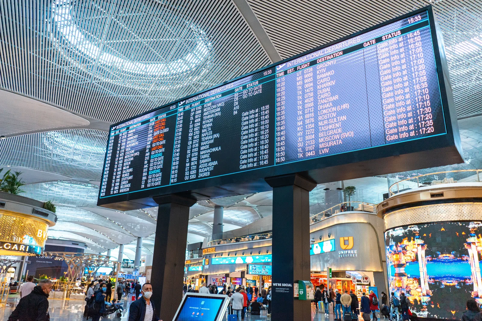 Airport departure board: checking flight details before international travel