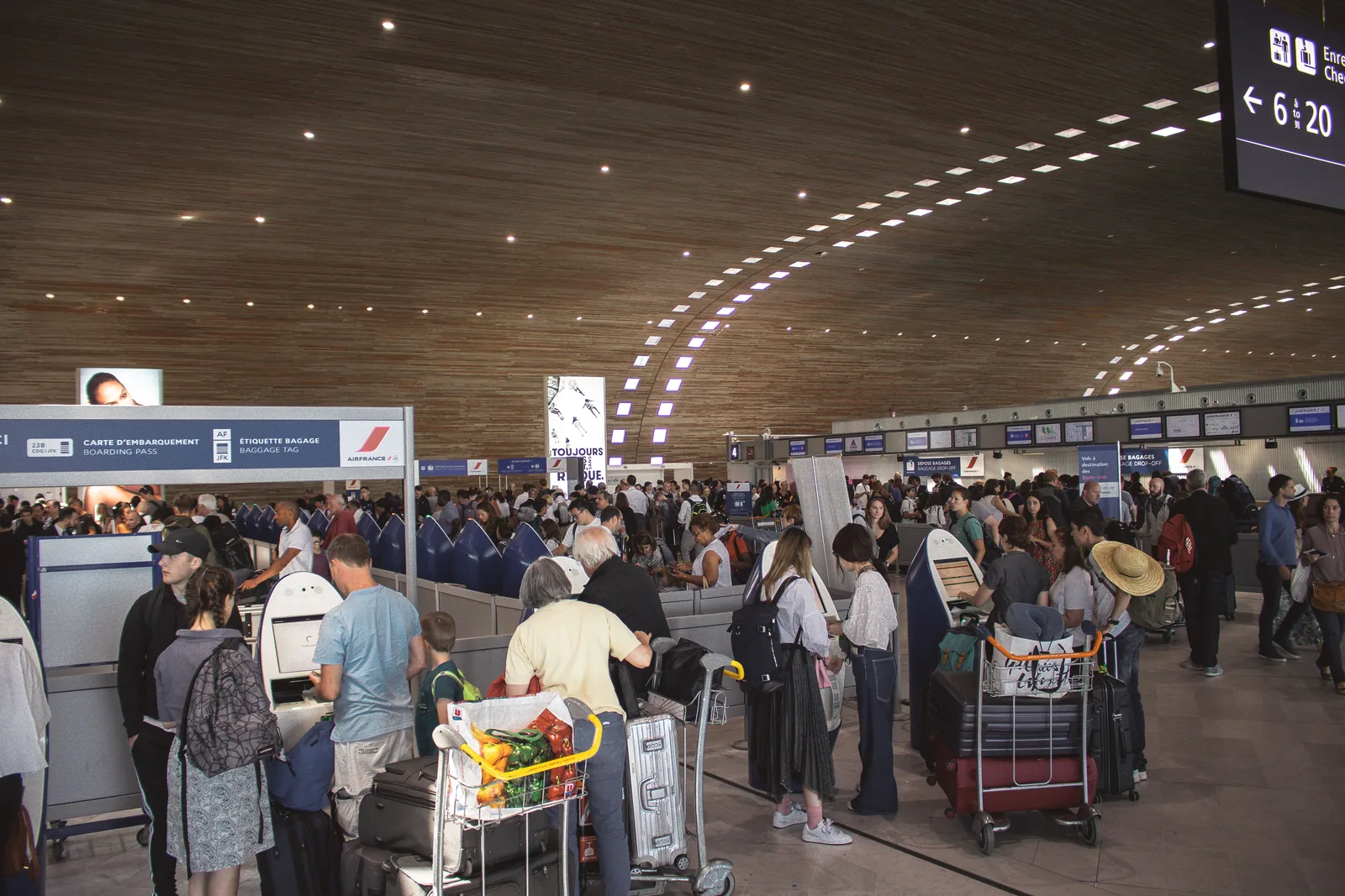 Crowded airport terminal with luggage carts