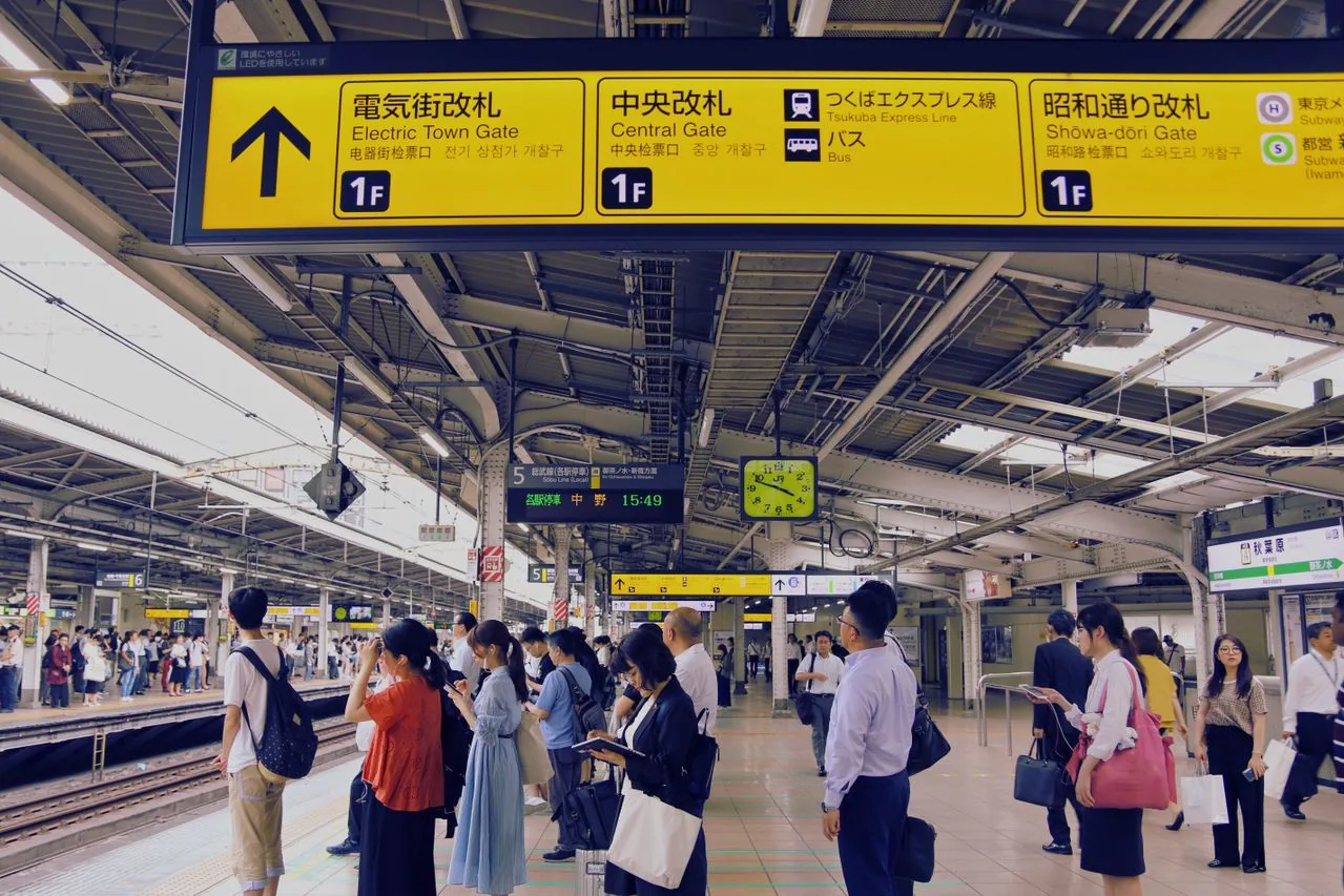 Busy train station platform in Asia: transport guide for food allergy travelers