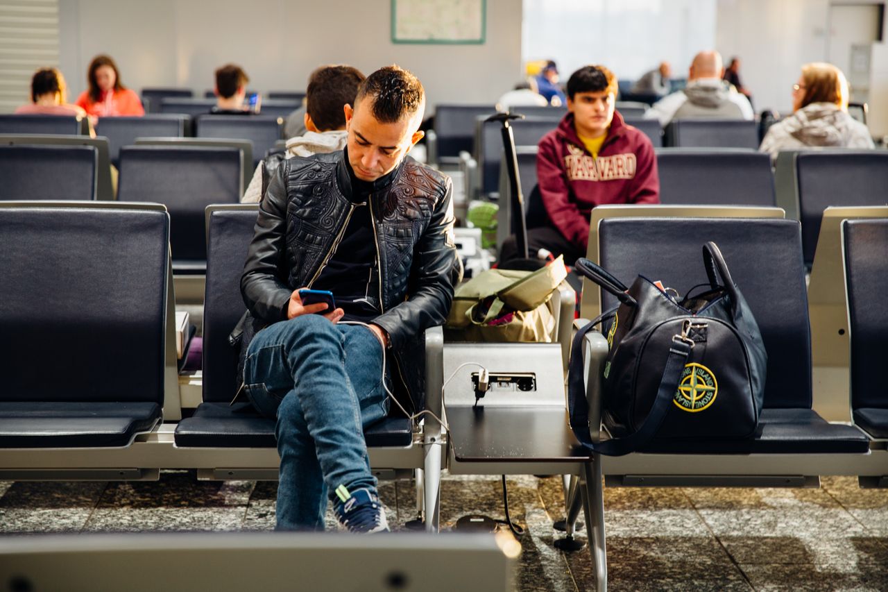 Traveler at the airport with a carry-on bag, prepared for a trip with food allergies